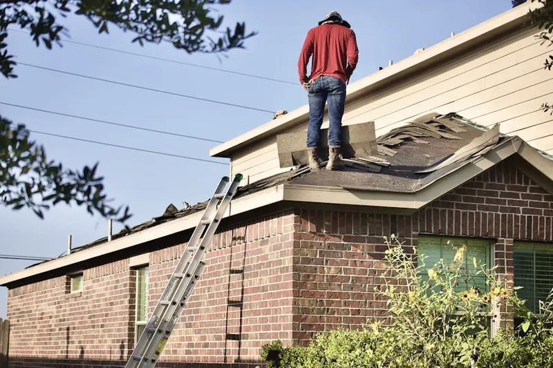 Professional roofer working on a residential roof in Brandywine Manor